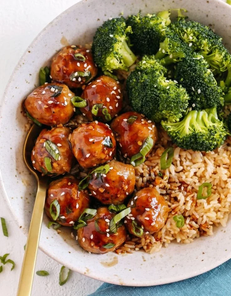 Asian-Glazed Turkey Meatballs served on a plate with dipping sauce