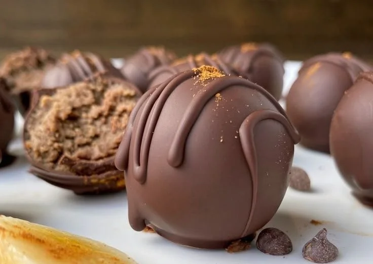 Homemade Banana Protein Balls stacked on a wooden table