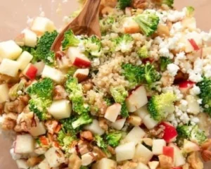 Fresh Broccoli Apple Quinoa Salad with ingredients displayed in a bowl