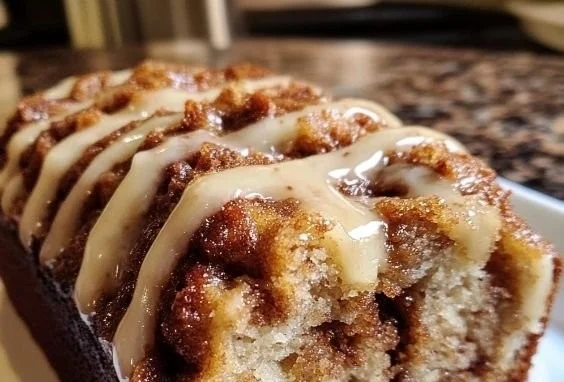 Cinnamon Roll-Style Banana Bread topped with cinnamon glaze