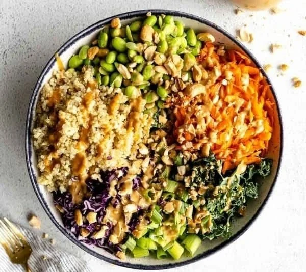 Bowl of crunchy Asian edamame salad with fresh vegetables and dressing