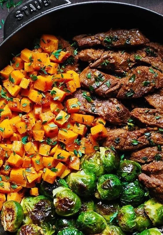 Garlic-Butter Steak with Brussels Sprouts and Sweet Potatoes on a plate