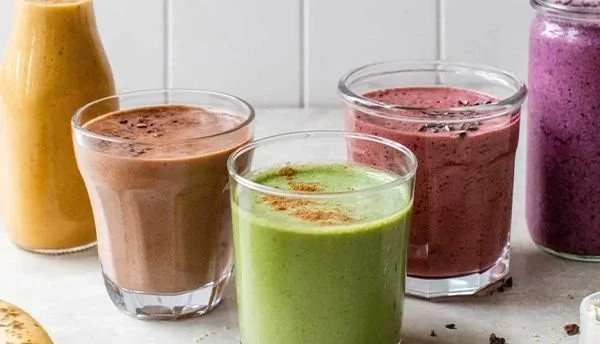 Delicious and healthy breakfast smoothies in colorful jars