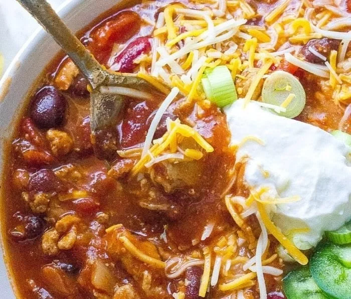 Bowl of healthy easy turkey chili topped with cilantro and avocado