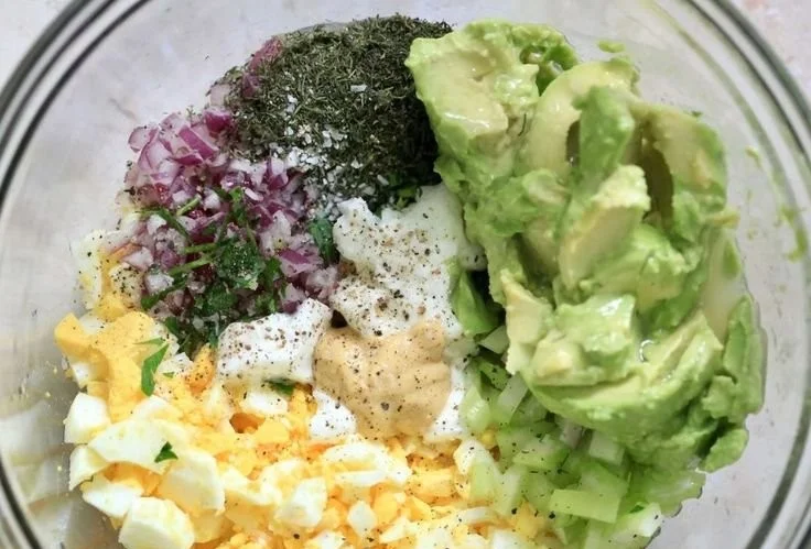 Herby avocado egg salad served in a bowl