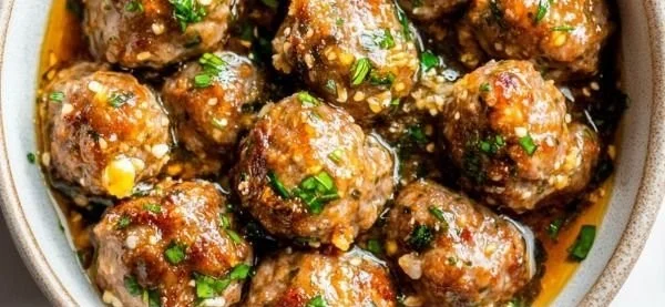 Keto Garlic Butter Meatballs served on a plate with herbs