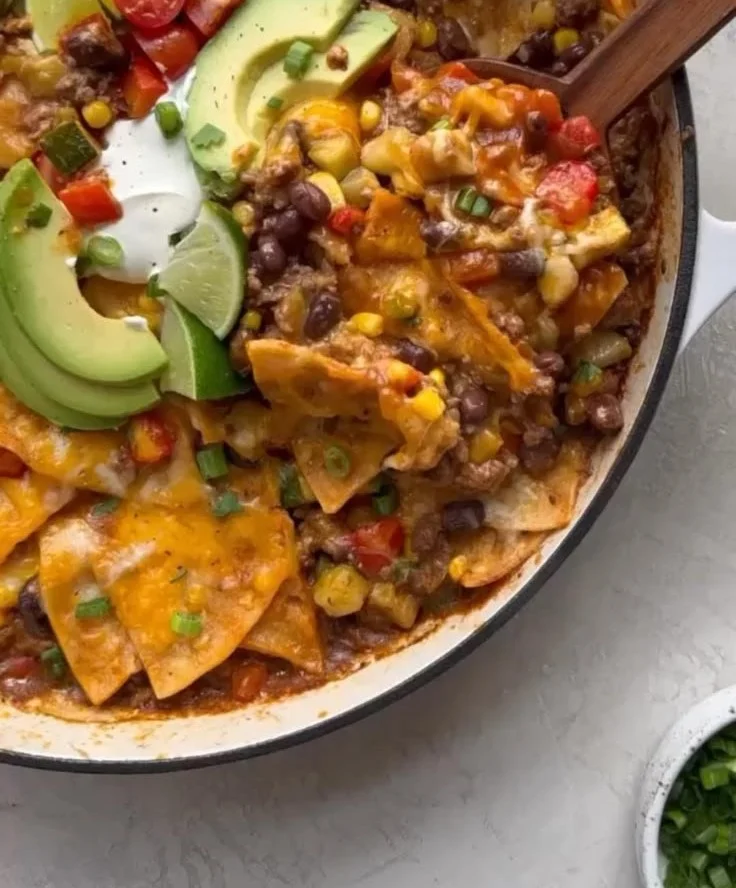 One Pan Beef Enchilada Skillet cooking in a frying pan with cheese and spices