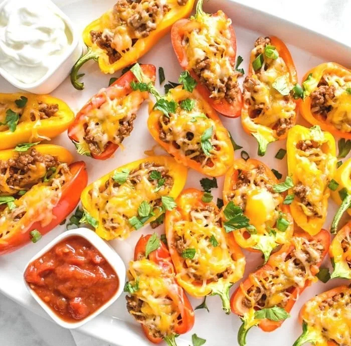 Colorful taco-stuffed mini bell peppers ready to be served as a delightful appetizer.